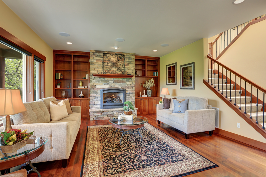 Living room of house with large woodfire fireplace 