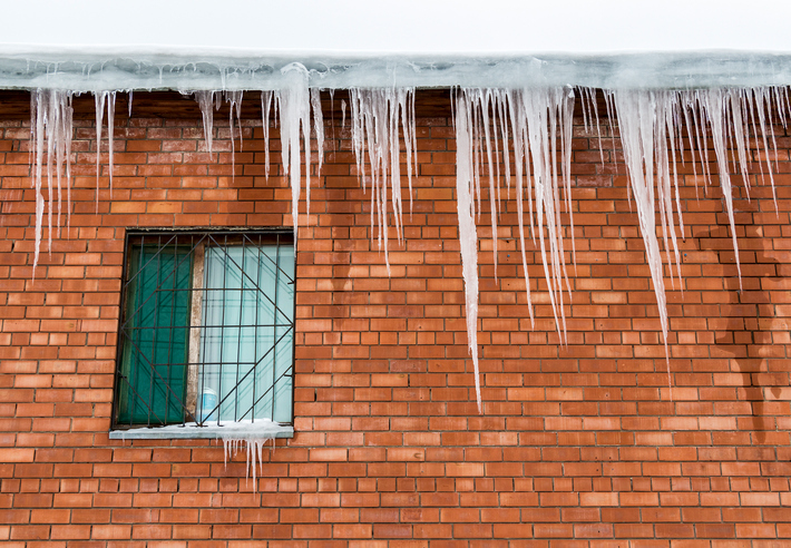 Large icicles hanging from gutter of building