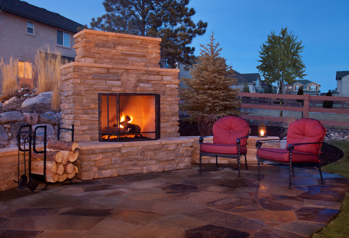 Outdoor wood burning fireplace on patio of back garden